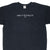 Upper front of black Nike T-shirt with white There Is No Finish Line embroidery and Swoosh