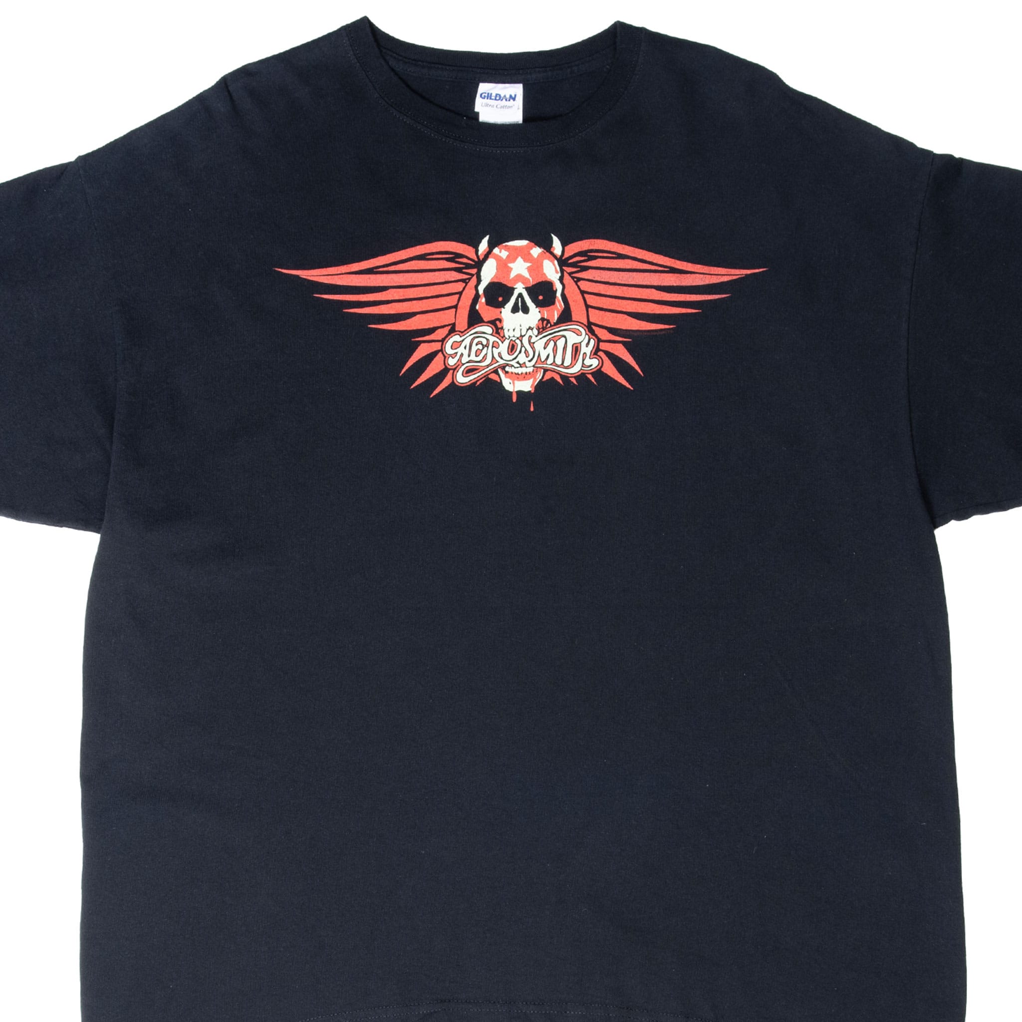 Upper front of black Aerosmith T-shirt with red and white winged horned skull graphic