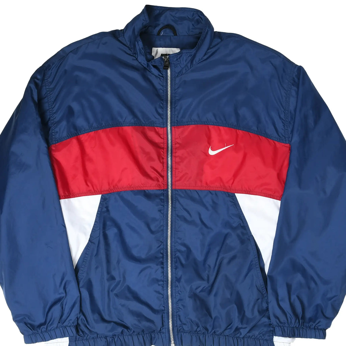 Front of navy Nike windbreaker jacket with red chest stripe, white panels, and embroidered Swoosh