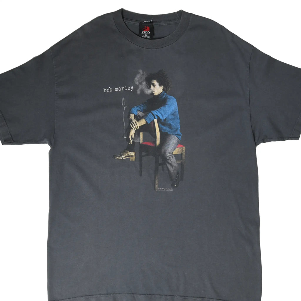 Front of grey Bob Marley T-shirt with seated portrait graphic and small white name text