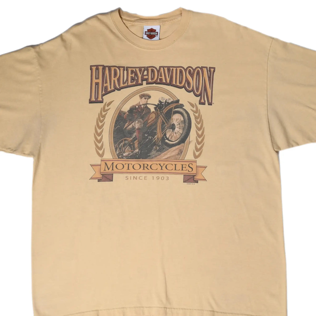 Front of tan Harley-Davidson T-shirt with motorcyclist and Motorcycles Since 1903 graphic
