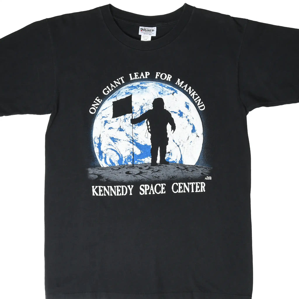 Front of black Kennedy Space Center T-shirt with astronaut, flag, and Earth graphic
