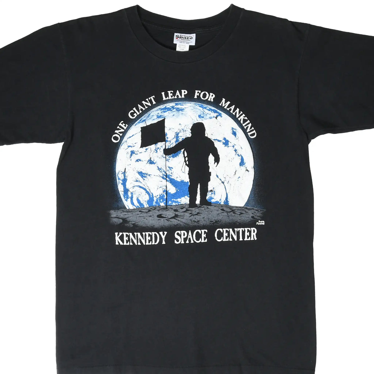 Front of black Kennedy Space Center T-shirt with astronaut, flag, and Earth graphic