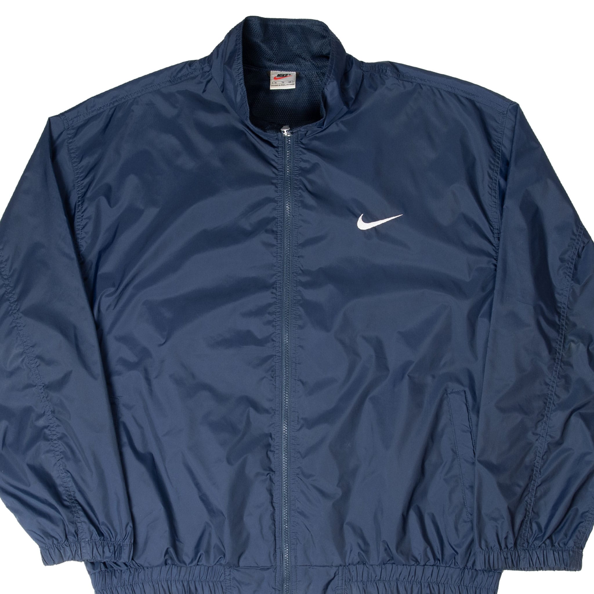 Front close view of navy Nike full-zip windbreaker with white embroidered Swoosh
