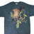 Front of blue-gray The Mountain T-shirt with large fire-breathing dragon graphic