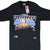 Front of black Cleveland Cavaliers T-shirt with blue, orange and white basketball graphic and hang tag