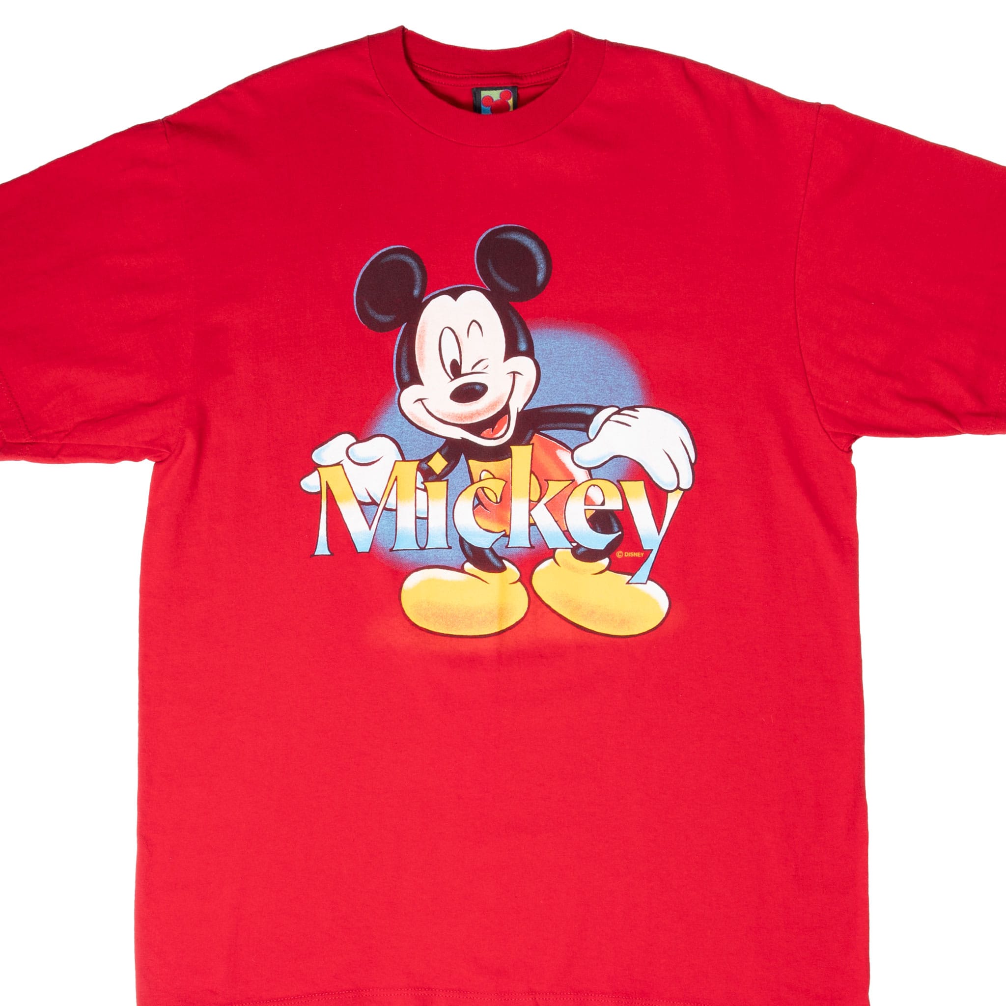 Front of red Disney T-shirt with smiling Mickey Mouse and multicolor Mickey lettering
