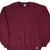 Front view of burgundy Russell Athletic crewneck sweatshirt with ribbed cuffs, hem logo tag, and V-stitch collar