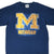 Upper front of navy Michigan Wolverines T-shirt with maize block M and water-drop graphic