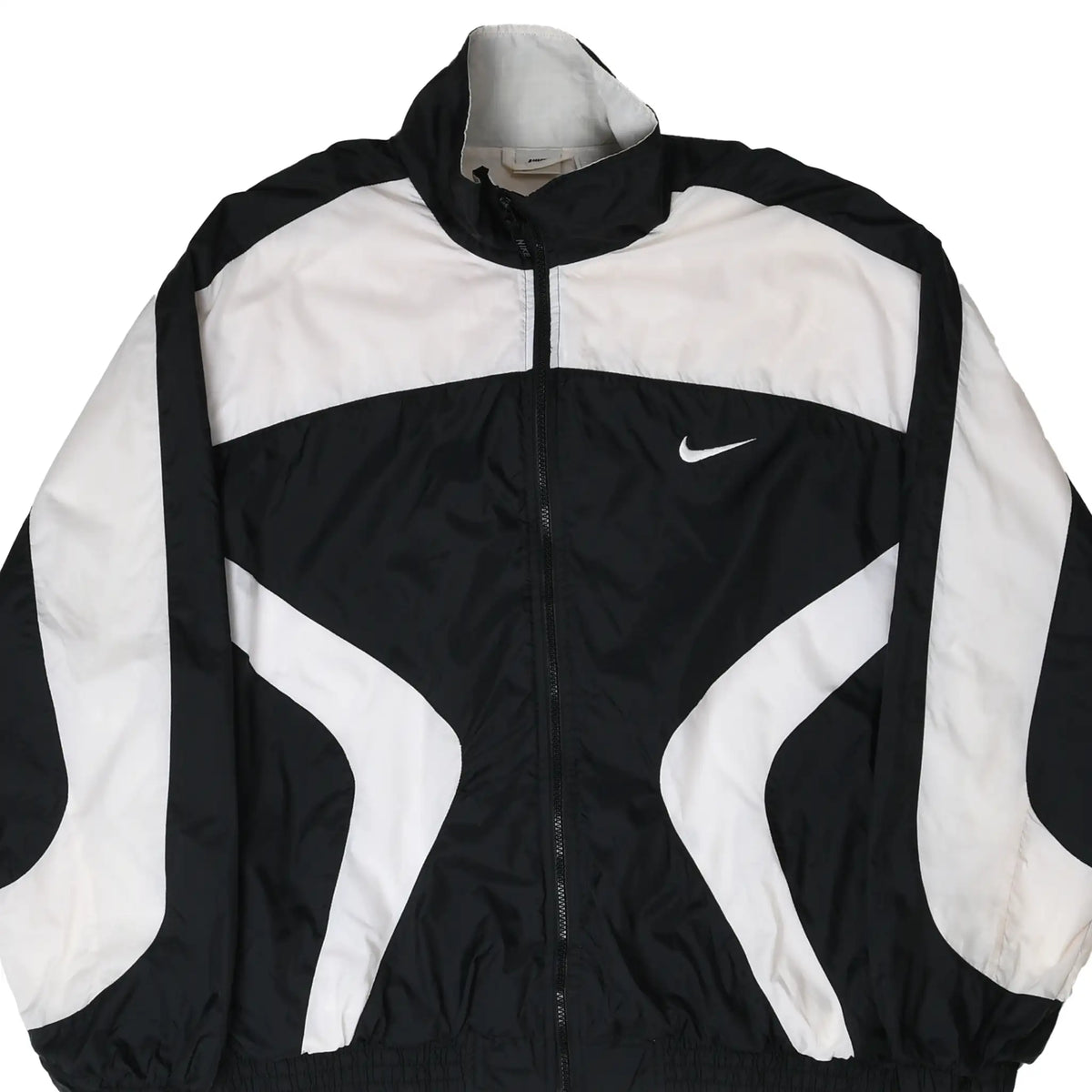 Front close-up of black and white Nike zip-up windbreaker with Swoosh embroidery
