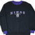 Front of black Sacramento Kings sweatshirt with purple collar, cuffs, and embroidered NBA logo