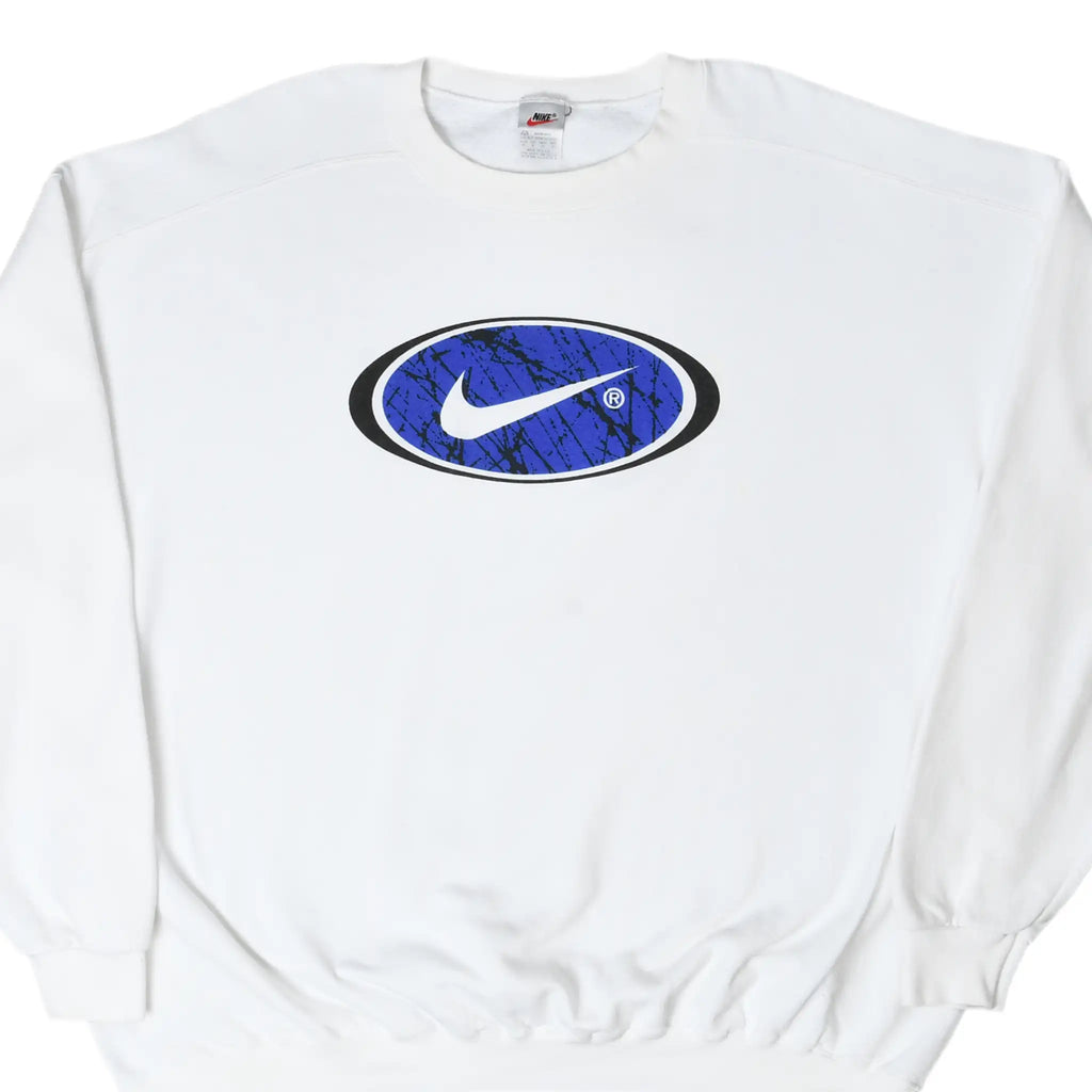 Front of white Nike sweatshirt with a large white Swoosh in a blue and black oval chest graphic
