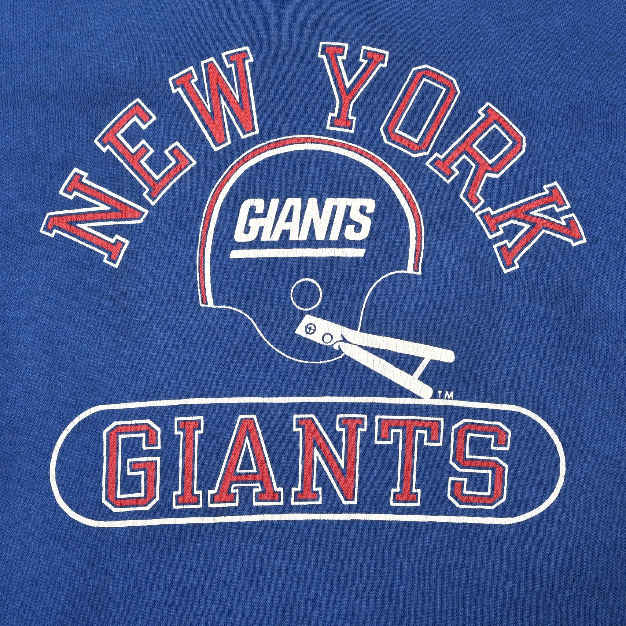Close-up of New York Giants helmet graphic and red-and-white lettering on blue shirt