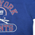 Close-up of New York Giants chest print, blue fabric, and right underarm seam