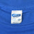 Close-up of CHED by Anvil XL neck tag on blue T-shirt
