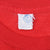 Close-up of neck tag marked large and Made in USA inside red T-shirt