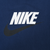 Close-up of white Nike spellout and black Swoosh print on navy blue fabric
