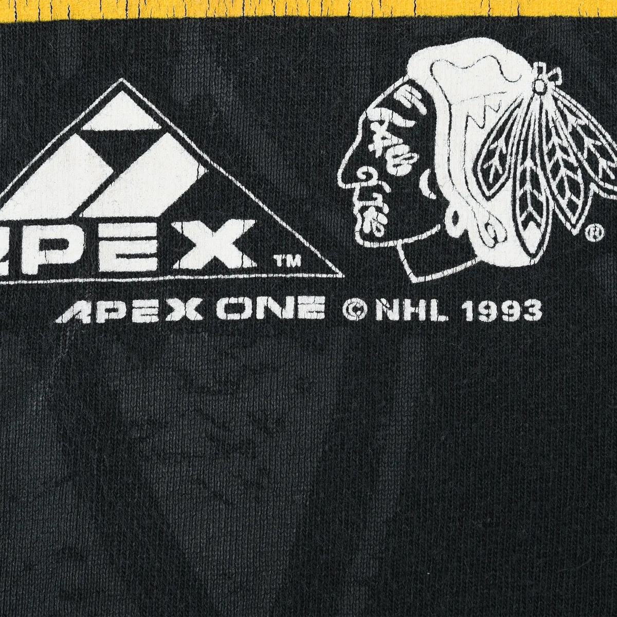 Close-up of Apex One, Chicago Blackhawks and NHL 1993 marks printed on black fabric