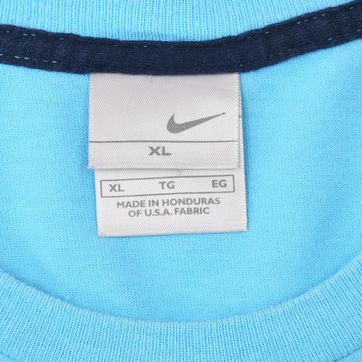 Nike neck tag marked XL inside light blue T-shirt