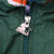 Close-up of metal Starter logo zipper pull on green jacket