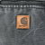Close-up of Carhartt logo patch below the zip chest pocket