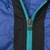 Close-up of teal front zipper and Nike Swoosh zipper pull on blue and black windbreaker