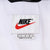Nike neck label with black logo, red Swoosh and large size marking