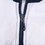 Close-up of navy front zipper and Nike Swoosh pull on white fabric