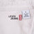Levi's Jeans neck label and size large care tag inside white denim shirt