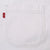 Close-up of chest pocket stitching and red Levi's tab on white denim shirt
