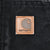 Close-up of Carhartt logo patch stitched to black jacket pocket