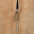 Close-up of metal Carhartt zipper pull on brown jacket fabric