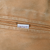Carhartt fabric logo tab on brown zippered jacket pocket