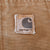 Close-up of Carhartt logo patch on brown front pocket