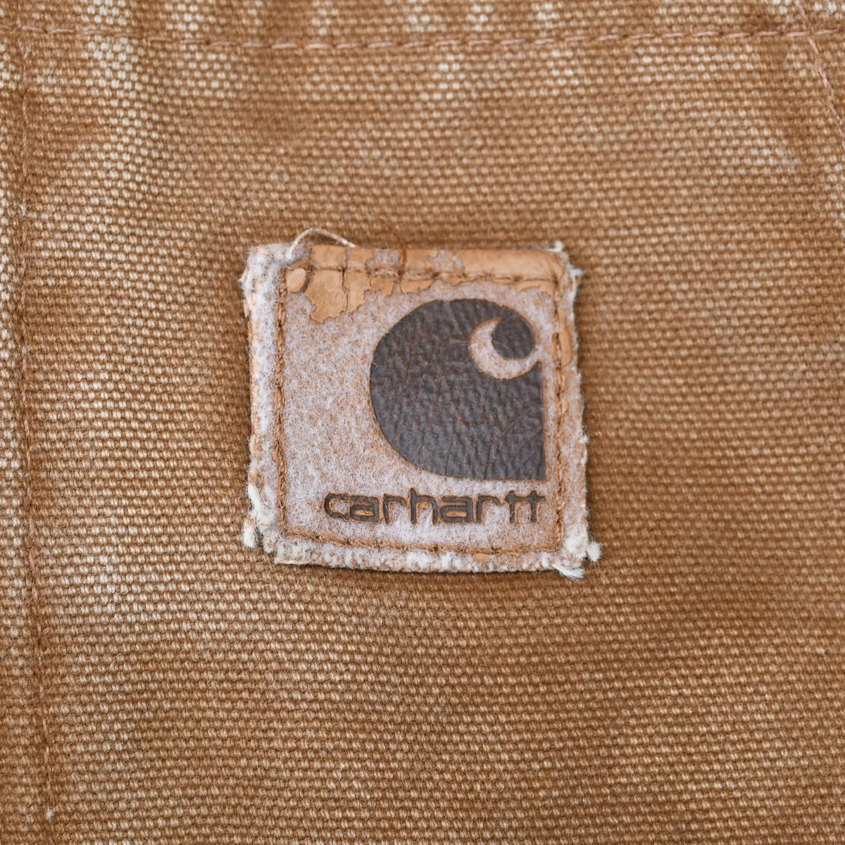 Close-up of Carhartt logo patch on brown front pocket