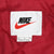 Nike logo and size large label on red quilted jacket lining