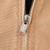 Close-up of Carhartt engraved metal zipper pull on brown jacket