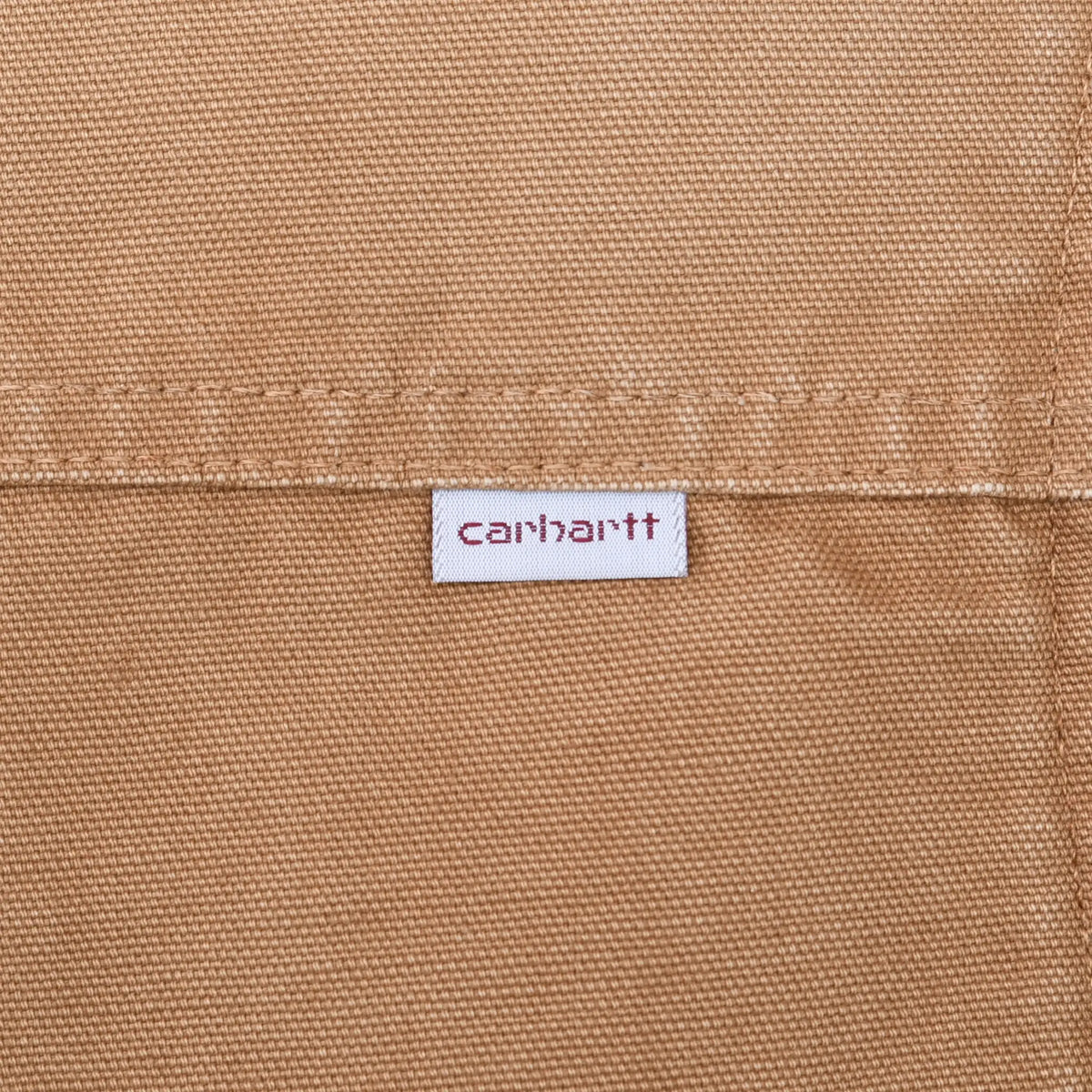 Close-up of Carhartt brand tab stitched to brown vest exterior