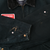 Close-up of jacket sleeves and cuffs showing scuffs, paint spots, and brass-tone snaps