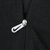 Close-up of silver Nike Swoosh zipper pull on black windbreaker jacket