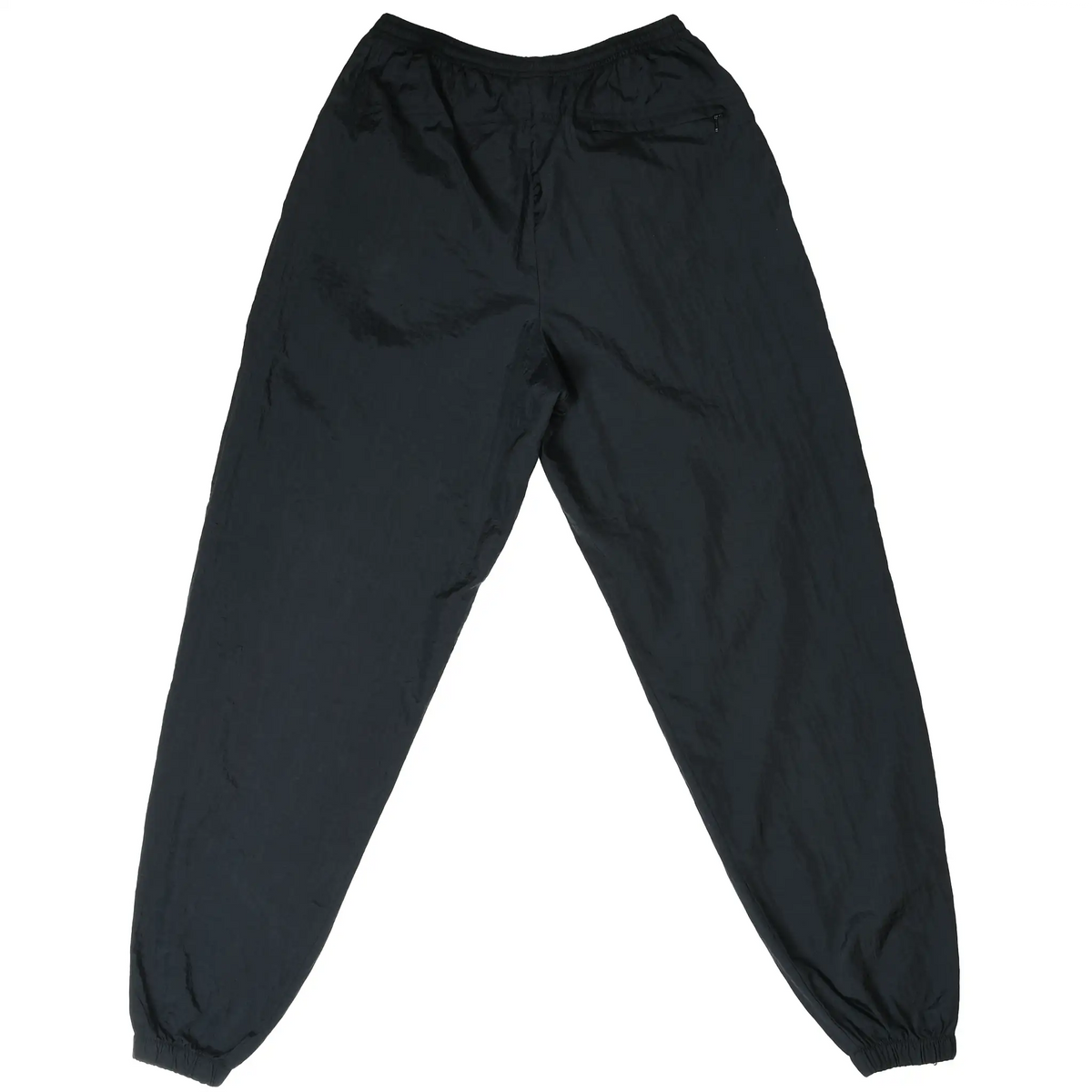 Back of black Nike nylon track pants with zippered rear pocket and elastic cuffs