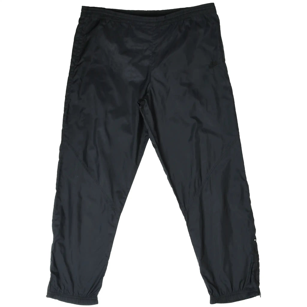 Front of black Nike women's track pants with elastic waistband and cuffs