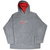 Front of grey Nike fleece hoodie with red hood lining and red and white embroidered logos