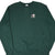 Front of dark green Champion crewneck sweatshirt with small embroidered chest logo