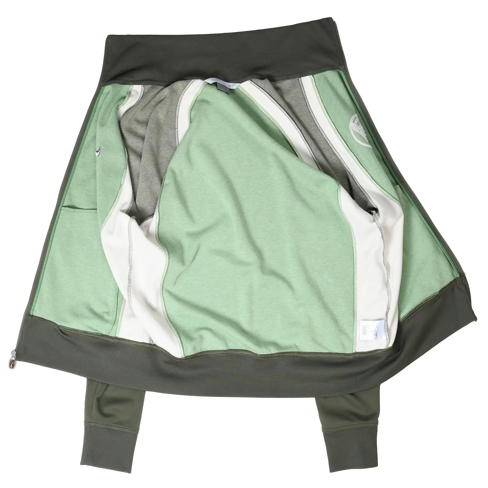 Inside-out view of green Nike Athletics track jacket showing interior seams and panels