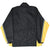 Back of black Nike windbreaker with yellow sleeve panels and gray striped trim