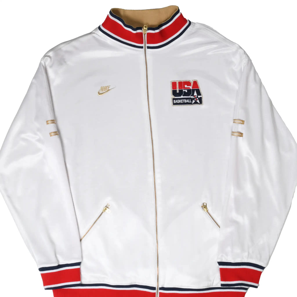 Front of white Nike USA Basketball track jacket with gold zipper and red and navy striped trim