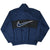 Back of navy Nike windbreaker with oversized outlined Swoosh on black panel