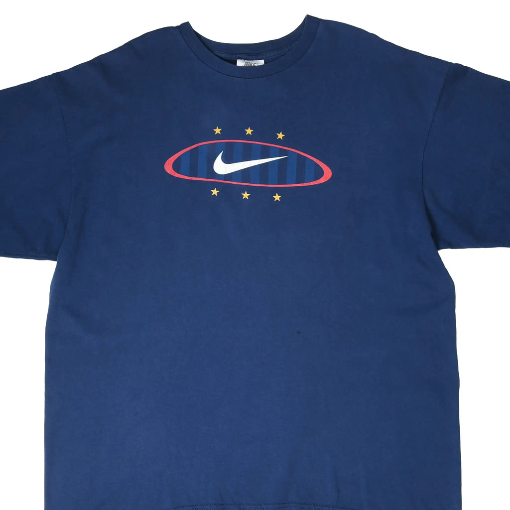 Front of blue Nike T-shirt with white Swoosh, red oval, blue stripes, and yellow stars