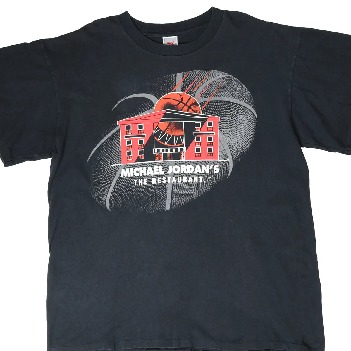 Front of black Nike T-shirt with Michael Jordan's The Restaurant basketball and building graphic